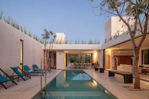 Swim as dusk settles over the open-air courtyard