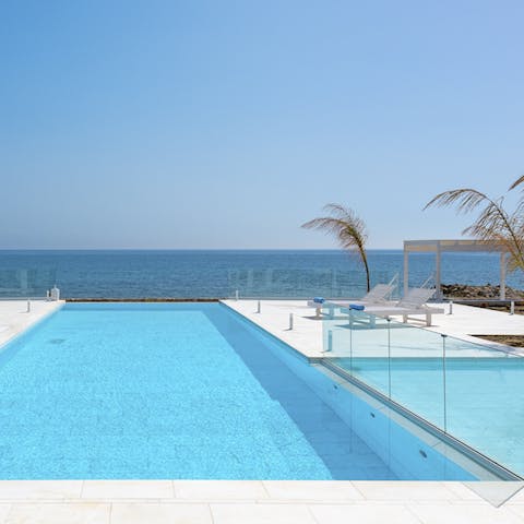 Dip in the pool stress-free while watching the kids through a sleek glass partition