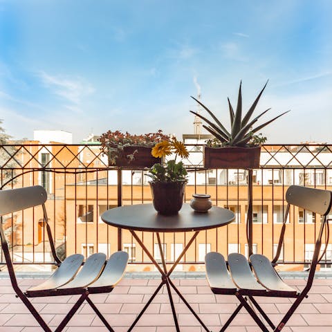 Take in the views over the rooftops of Milan from the private balcony