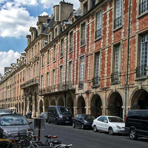 Enjoy a croissant in the historic Place de Voges square,  just a thirteen-minute walk away