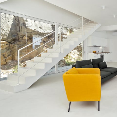 The natural cliff face can be seen in the glass wall by the stairs