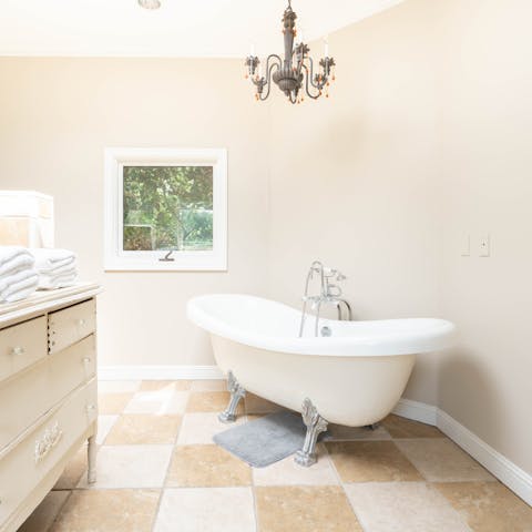 Treat yourself to an indulgent soak in the clawfoot tub]