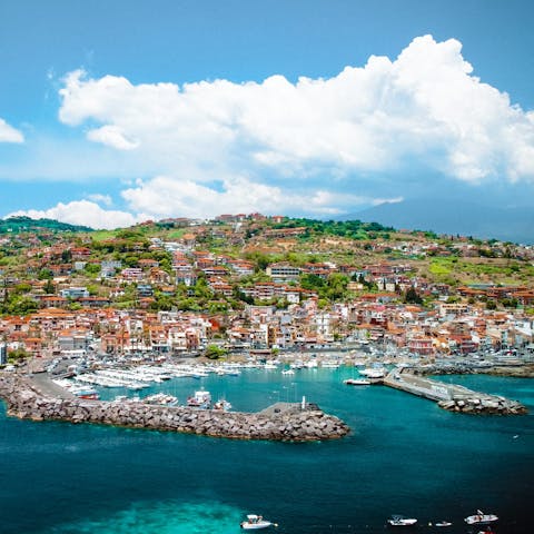 See the seaside town of Aci Trezza (twenty-five minutes by car)