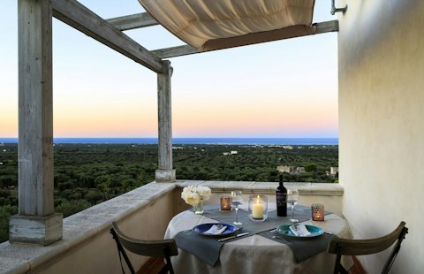 Dine by candlelight as the sun drops over the valley