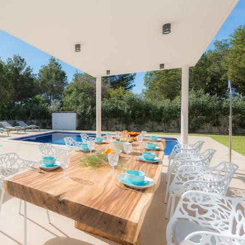 Enjoy an alfresco meal overlooking the pool