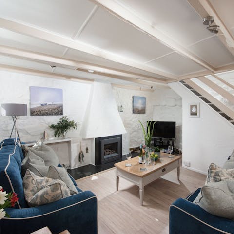 Gather round the fireplace for a cosy evening in with a movie to end a busy day