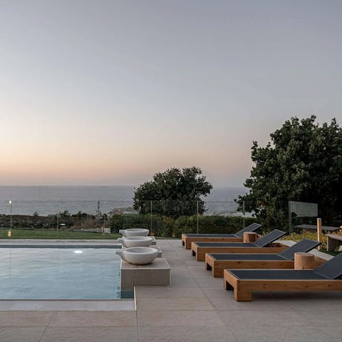 Watch the sun as it descends beyond the horizon from your poolside patio