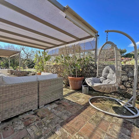 Recline in shaded outdoor lounges and escape the heat