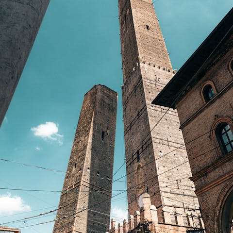 Gaze up at the Two Towers, Asinelli and Garisenda, a ten-minute walk away