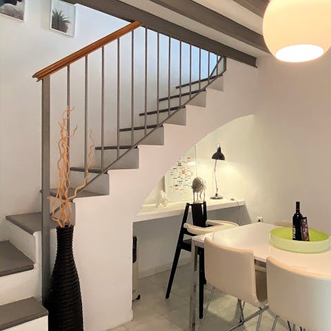 Retreat to this lamplit alcove under the stairs, a perfect desk for remote workers