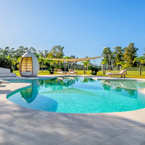 Spend days by the pool, reclining in splendour