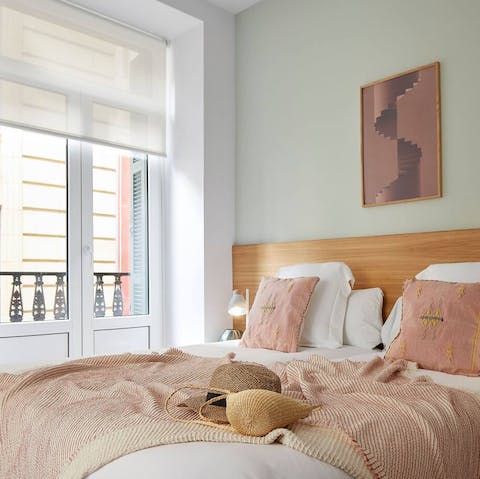 Snuggle under blush-coloured sheets
