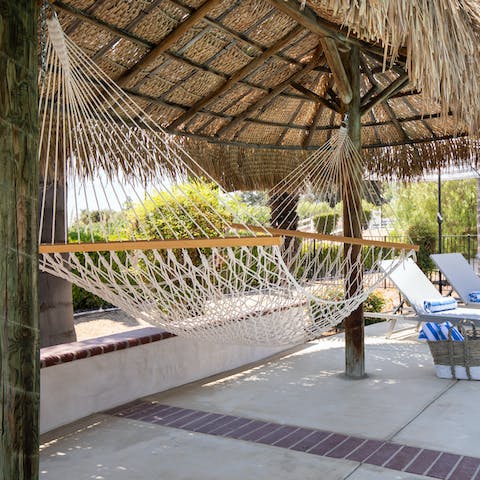 Loll about in the hammock with a good book in hand