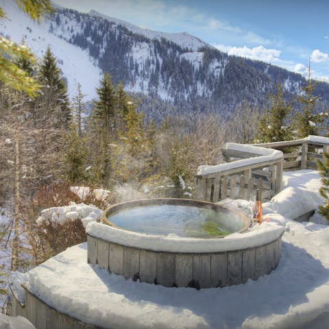 Soak in the hot tub while admiring the mountain scenery