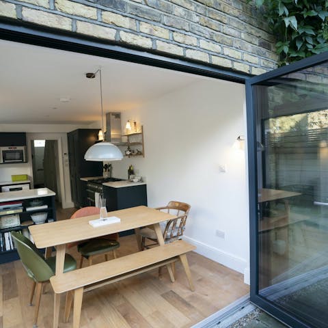 Open up the bi-fold doors as you play games around the dining table