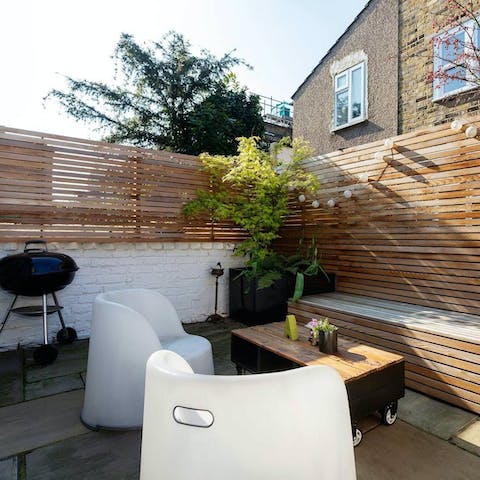 Enjoy a glass of wine in the private garden before a barbecue dinner