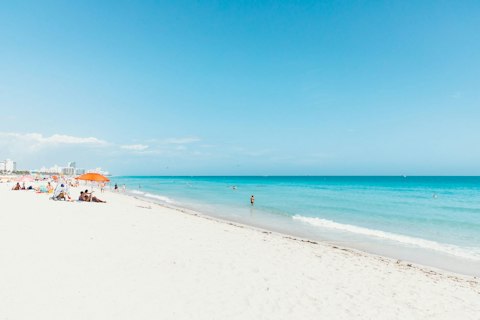Stroll along the iconic South Beach, a fifteen-minute drive away