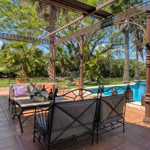 Sip cocktails on the wrought-iron patio furniture