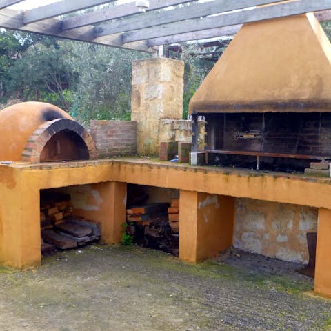 Work culinary magic in the outdoor kitchen and serve up to guests on the covered terrace