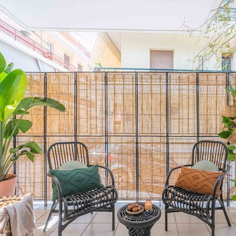 Relax with a glass of Greek wine on the private balcony