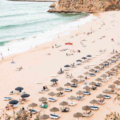 Enjoy a day by the crystal clear sea on the golden shores of Meia Praia