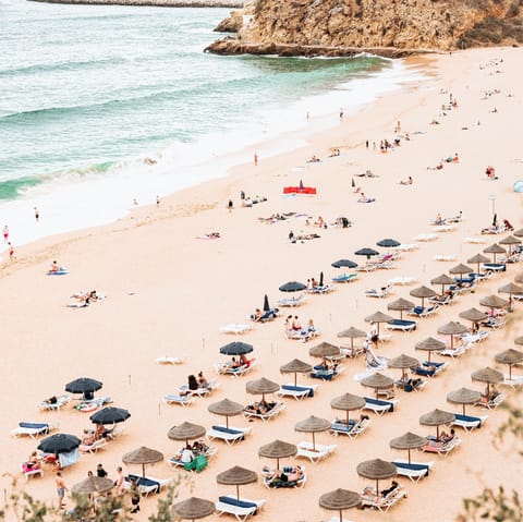 Enjoy a day by the crystal clear sea on the golden shores of Meia Praia