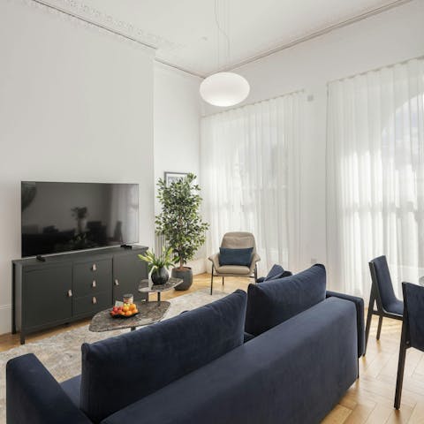 Relax in the bright living area, admiring the views across Plymouth Hoe