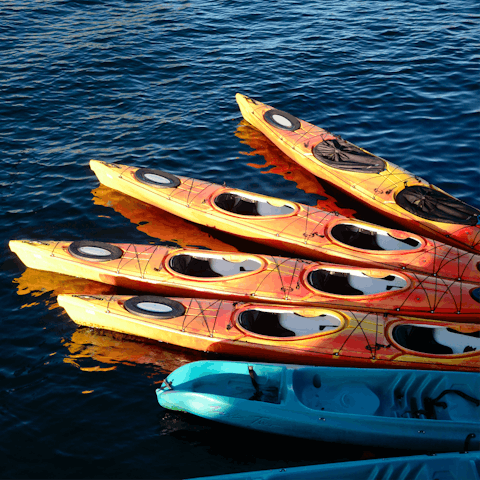 Hire kayaks or paddleboards for a day of watersports on the lake