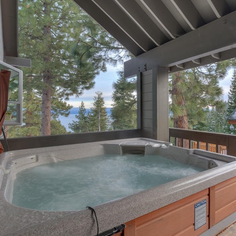 Relax in the hot tub with its pine tree vistas