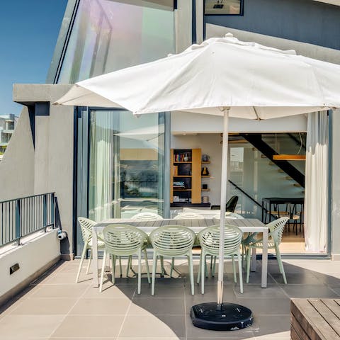 Gather around the outdoor dining table for a glass or two of Stellenbosch