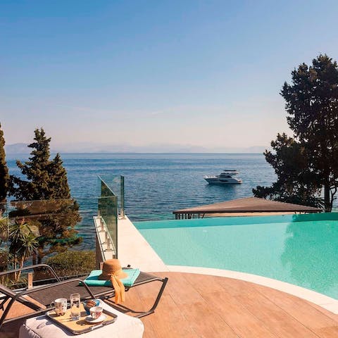 Sunbathe by the pool underneath the clear blue sky