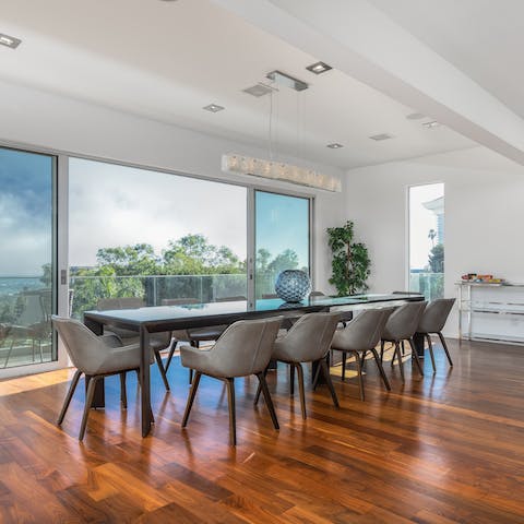 Gather the group at the huge dining table overlooking the city skyline