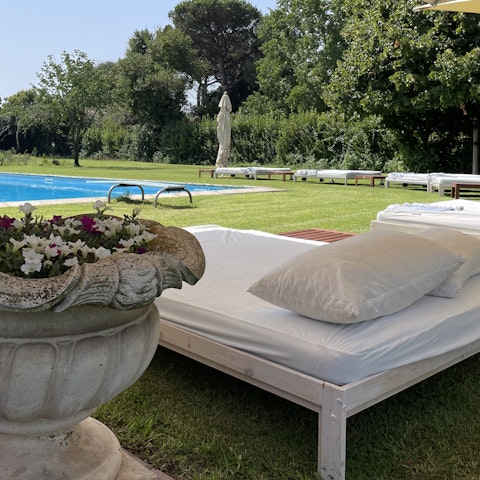 Lounge poolside with a good book and an Aperol Spritz