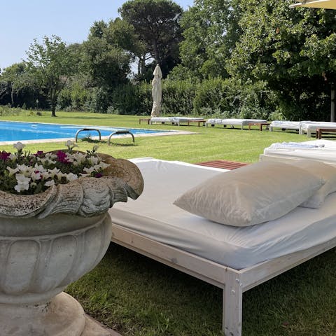 Lounge poolside with a good book and an Aperol Spritz