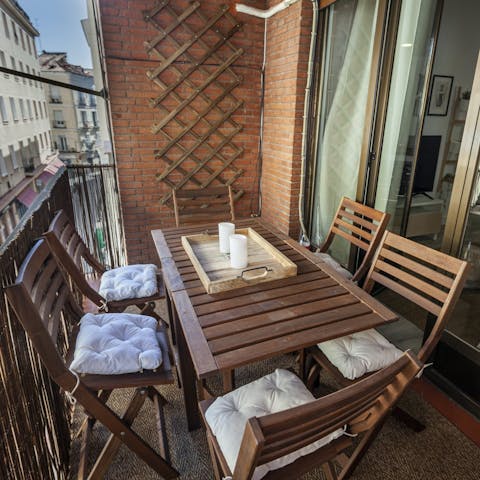 Enjoy a glass of wine on the balcony before heading into La Latina for tapas