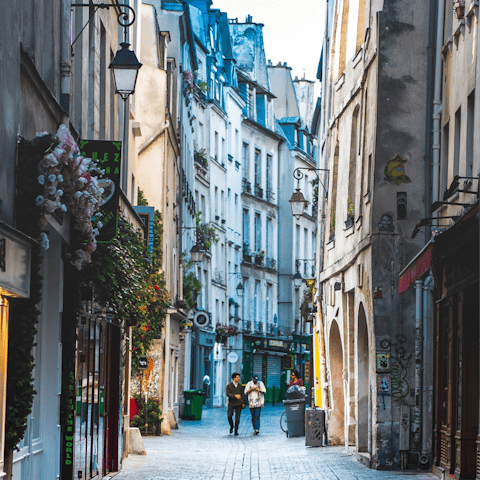 Explore Le Marais' historic streets awaiting outside