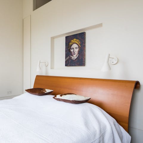 Get a peaceful night's sleep in the arty master bedroom