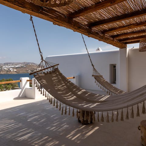 Swing in the shaded hammocks under the pergola