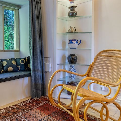 Relax in the window seat or the wicker rocking chair with a classic novel