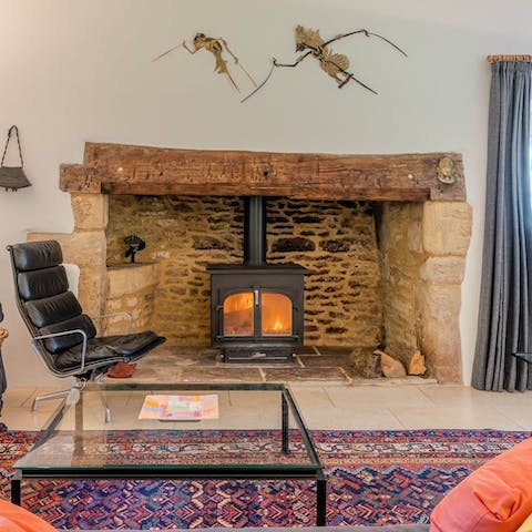 Gather around the inglenook fireplace and put some logs on the stove