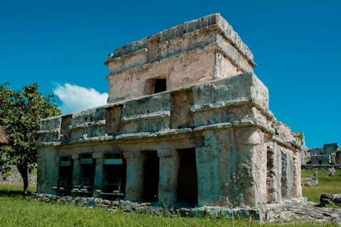 Explore ancient Mayan ruins perched dramatically above turquoise Caribbean waters