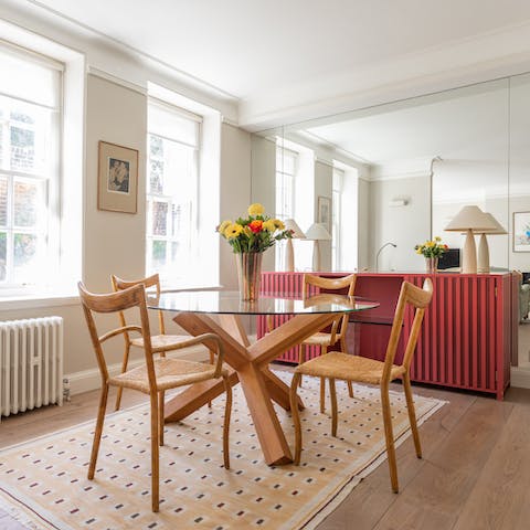 Tuck into a sumptuous supper at the chic glass-topped dining table