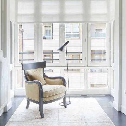 Curl up with a book in front of the large windows