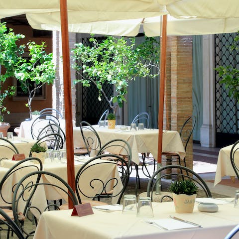 Dine like a local in the courtyard restaurant that belongs to the restored historic building you'll be staying in