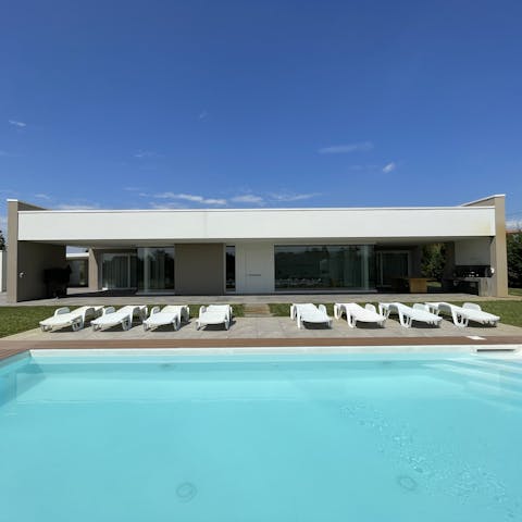 Relax on a lounger overlooking the private pool