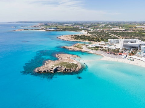 Swim at the iconic Nissi Beach, one of Cyprus's most beautiful sandy shores