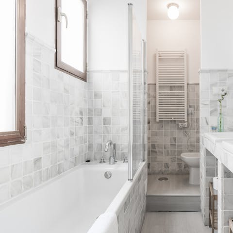Treat yourself to a soak in the main bedroom's en-suite tub after a day of touring the city on foot