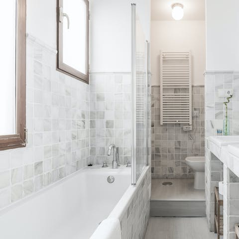 Treat yourself to a soak in the main bedroom's en-suite tub after a day of touring the city on foot