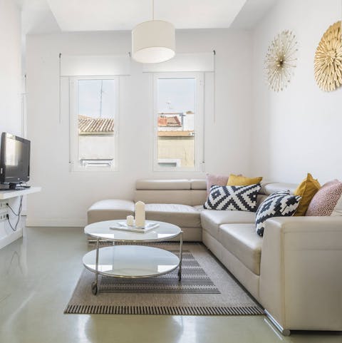 Relax and unwind in the bright living room, a glass of Spanish wine in hand
