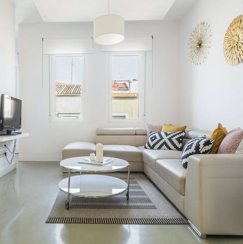 Relax and unwind in the bright living room, a glass of Spanish wine in hand